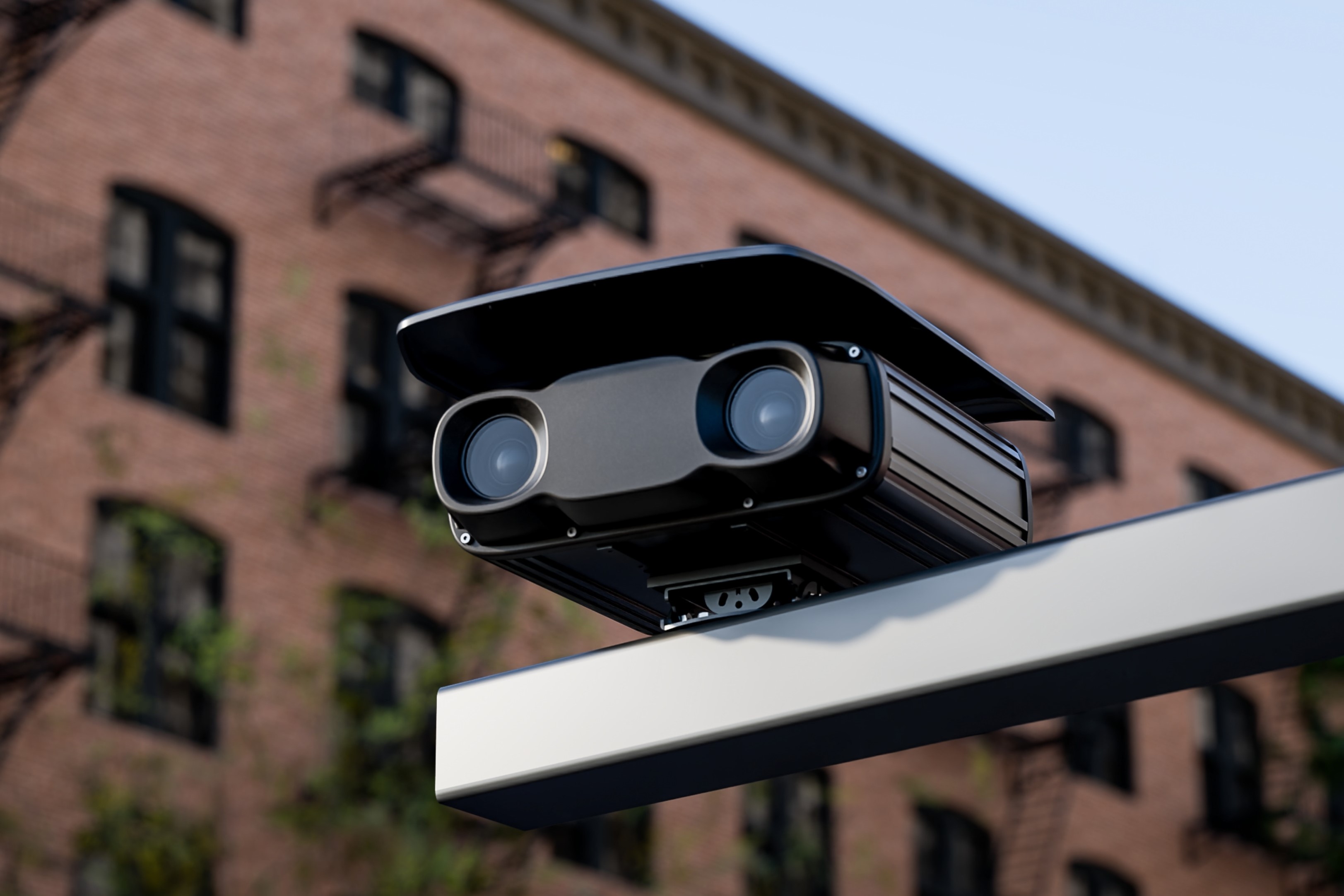 Ekin Box Spotter dual-lens unit mounted on a street-side arm above a city block