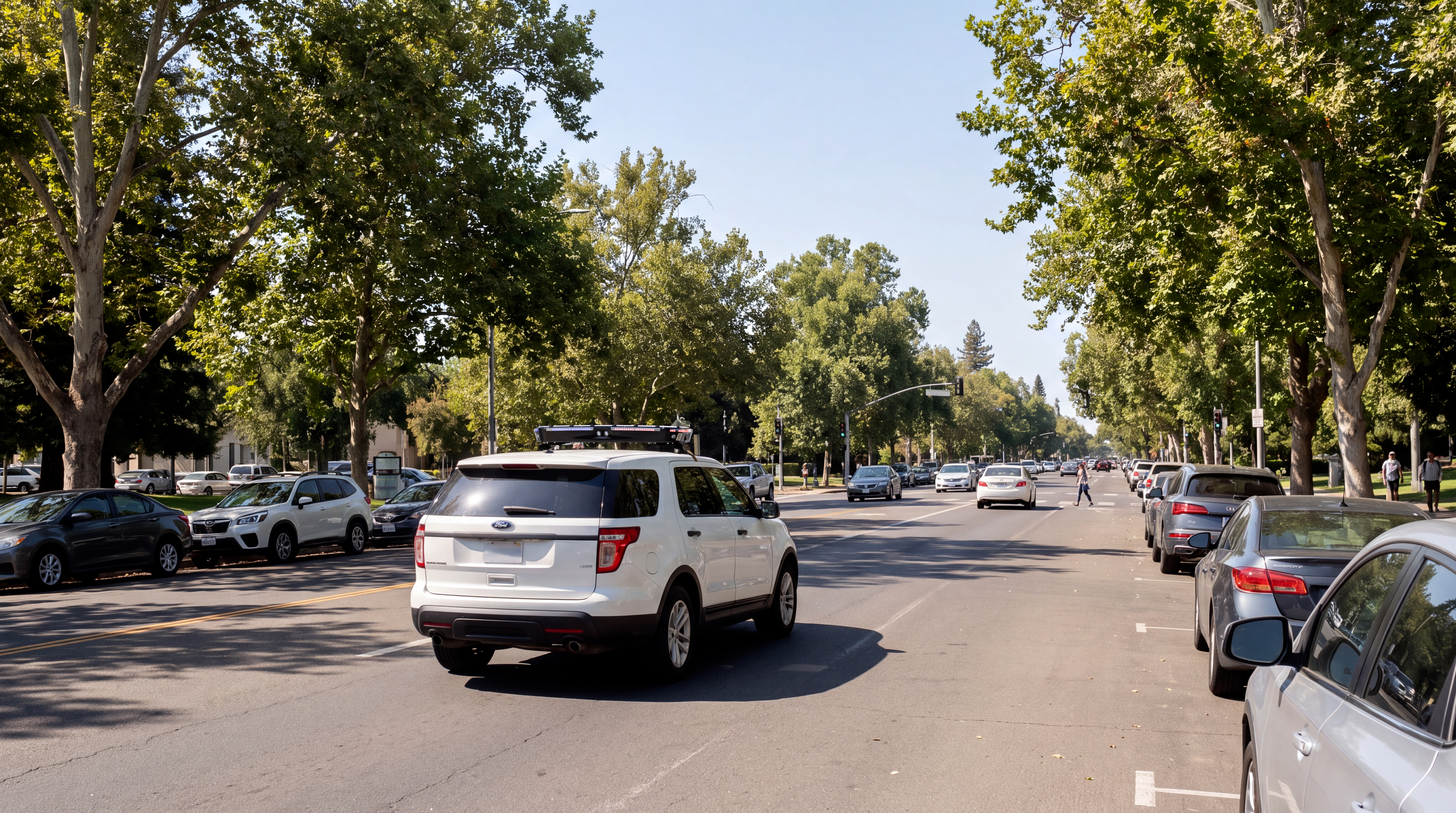 Ekin Patrol G2 equipped vehicle driving a tree-lined city avenue